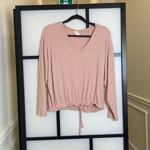Pink sweater with tie at the bottom